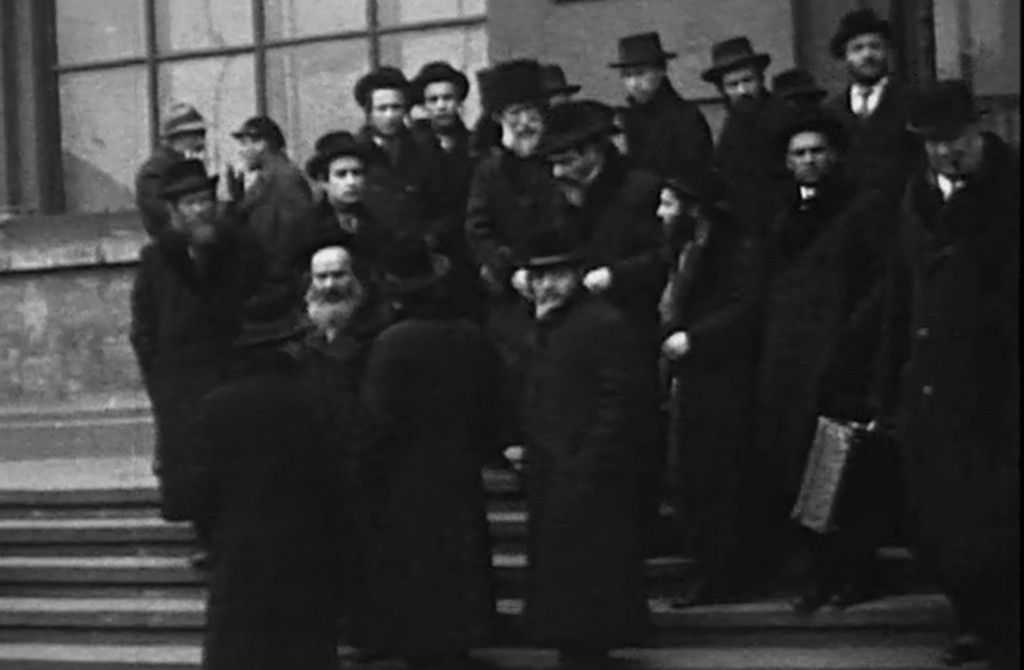 Chasidim in long coats and hats descending the stone steps of Lwów’s main railway station, 1929